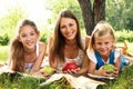 Three beautiful girls relaxing in park Royalty Free Stock Photo