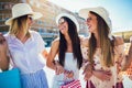 Beautiful girls in sunglasses with shopping bags in city Royalty Free Stock Photo