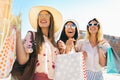 Beautiful girls in sunglasses with shopping bags in city Royalty Free Stock Photo