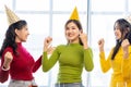 Three beautiful girls wearing party hats are having fun celebrating their birthday Royalty Free Stock Photo