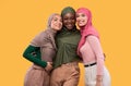 Three Beautiful Islamic Women In Hijab Posing Over Yellow Background Royalty Free Stock Photo