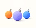 Three beautiful orange, purple, blue christmas balls or spheres. 3d rendered christmas ornament icons isolated on white Royalty Free Stock Photo