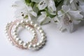Three beautiful pink and white bracelets and white flowers
