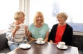 Three beautiful senior women enjoying retirement together having tea or coffee Royalty Free Stock Photo