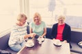 Three beautiful senior women enjoying retirement together having tea or coffee Royalty Free Stock Photo