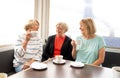 Three beautiful senior women enjoying retirement together having tea or coffee Royalty Free Stock Photo