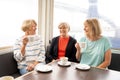 Three beautiful senior women enjoying retirement together having tea or coffee Royalty Free Stock Photo