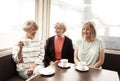 Three beautiful senior women enjoying retirement together having tea or coffee Royalty Free Stock Photo