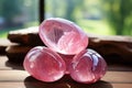 Three beautiful smooth rose quartz stones. Generative AI