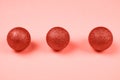 Three spheres on light coral background