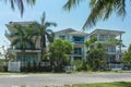 Three beautiful three-story houses with palm trees, trees, in the summer