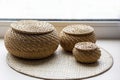 Three beautiful wicker boxes on the windowsill