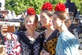 Three Beautiful women taking selfie photo at the Seville`s April Fair