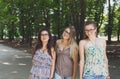 Three beautiful young boho chic stylish girls walking in park. Royalty Free Stock Photo