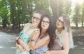 Three beautiful young boho chic stylish girls walking in park. Royalty Free Stock Photo