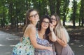 Three beautiful young boho chic stylish girls walking in park. Royalty Free Stock Photo