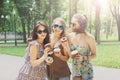 Three beautiful young boho chic stylish girls walking in park. Royalty Free Stock Photo