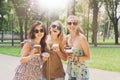 Three beautiful young boho chic stylish girls walking in park. Royalty Free Stock Photo