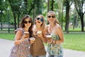 Three beautiful young boho chic stylish girls walking in park. Royalty Free Stock Photo