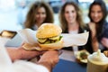 Three beautiful young women buying meatballs on a food truck. Royalty Free Stock Photo