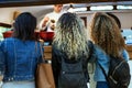 Three beautiful young women buying meatballs on a food truck. Royalty Free Stock Photo