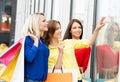 Three beautiful young women looking at a dress Royalty Free Stock Photo