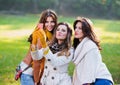 Three beautiful young women taking a photo Royalty Free Stock Photo