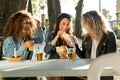 Three beautiful young women visiting eat market in the street. Royalty Free Stock Photo