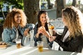 Three beautiful young women visiting eat market in the street. Royalty Free Stock Photo