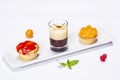 Three beautifully colored cakes on the plate and decoration on white background