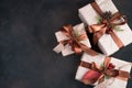 Three beautifully decorated gift boxes on a brown background.