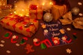 Three beautifully wrapped gifts await the start of the holiday surrounded by Christmas tree decorations