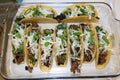 three beef tacos with cheese, lettuce and tomatoes Royalty Free Stock Photo