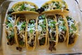 three beef tacos with cheese, lettuce and tomatoes Royalty Free Stock Photo