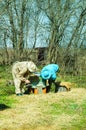 Three beekeepers work on an apiary at hive. Sunny day.