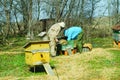 Three beekeepers work on an apiary at hive. Sunny day.