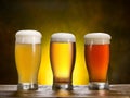 Three beer glasses on the wooden table.