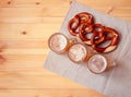 Three beer mugs and soft pretzels on wooden table. Top view, copy space Royalty Free Stock Photo