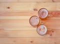 Three beer mugs on wooden table. Top view, copy space Royalty Free Stock Photo