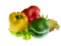 Three bell peppers with leaves lettuce isolated on white Royalty Free Stock Photo