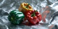 Three Bell Peppers on Silver Textured Background Royalty Free Stock Photo