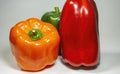 Orange, green and red bell pepers on white background Royalty Free Stock Photo