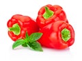 Three bell Red Peppers with green leaves basil isolated on white Royalty Free Stock Photo