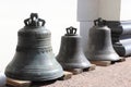 Three bells on wooden planks.