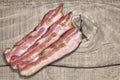 Bacon Rashers Set On Old Knotted Rough Pine Wood Table Surface Royalty Free Stock Photo