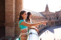 Three belly dancers on a balcony looking out and pointing to the horizon. The dancers are beautiful and adult. Concept of dance