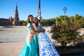 Three belly dancers dressed in light blue leaning on the railing of a bridge. They are talking to each other and looking at the Royalty Free Stock Photo