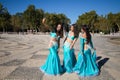 Three belly dancers are taking a photo with their mobile phones. They are dressed in light blue and are having fun. Concept of