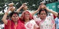 Three Bengali women performing Durga Puja