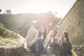 Three young girls sitting on the stairs at the public park. Royalty Free Stock Photo